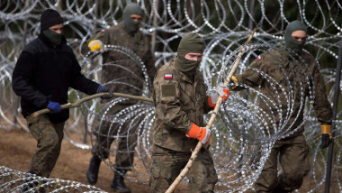 Polish soliders set up barbed wire fence in Border Zone near Krynki on September 1, 2021