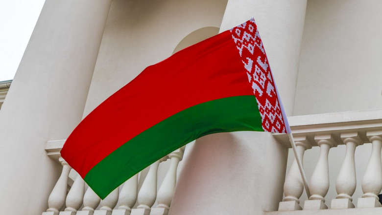 Drapelul statului Belarus arborat pe o clădire.