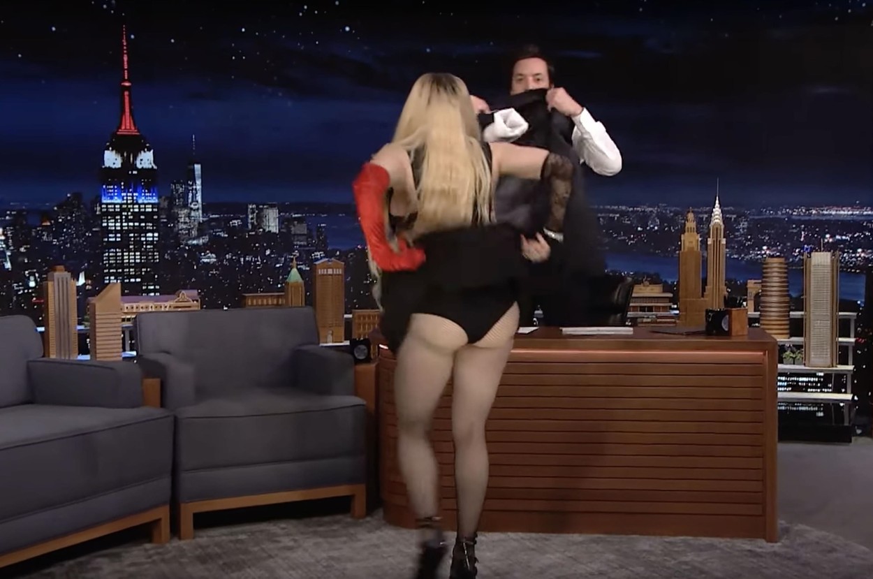 Madonna's interview with The Tonight Show's Jimmy Fallon goes completely off the rails as she climbs on his desk and then flashes the audience