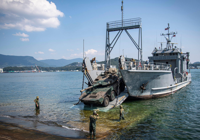 Japan Ground Self-Defense Force (JGSDF) service members, assigned to 22nd Rapid Deployment Regiment, Maneuver Combat Vehicle (MCV) Unit, offload JGSDF MCVs from U.S. Army Landing Craft, Utility (LCU) 2009, assigned to U.S. Army 836th Transportation Battal