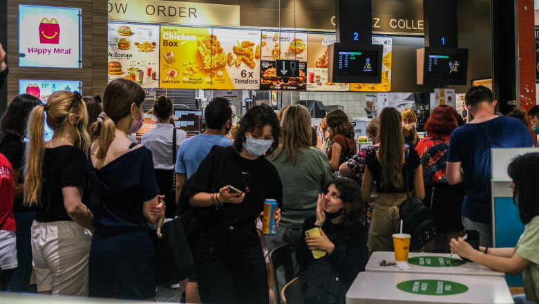 People wait for their orders at a McDonald's restaurant inside a shopping mall