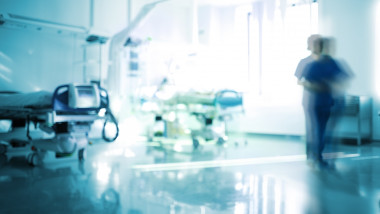 Blurred emergency room with walking staff, unfocused background