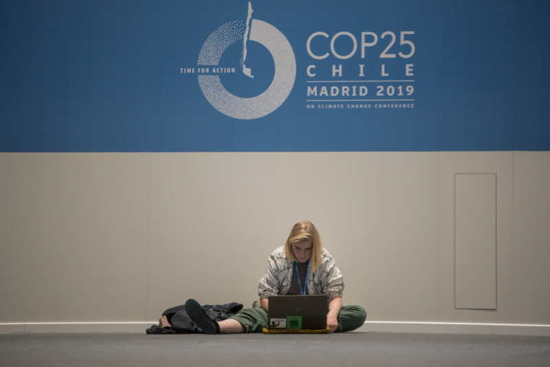 02-12-19 United Nations Climate Change Conference. (Madrid-Spain)A journalist work wit the laptop sitting on the carpet.Second day of COP25 Chile-Madrid 2019 25th session of the Conference of the Parties to the United Nations Framework Convent