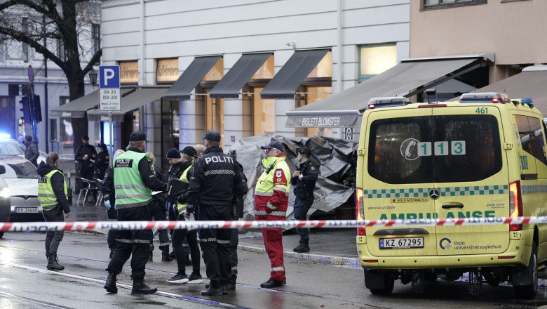 Police officers stand at the site where a person was shot by police at Bislett in Oslo, Norway, on November 9, 2021.