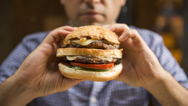 Man holding a big hamburger