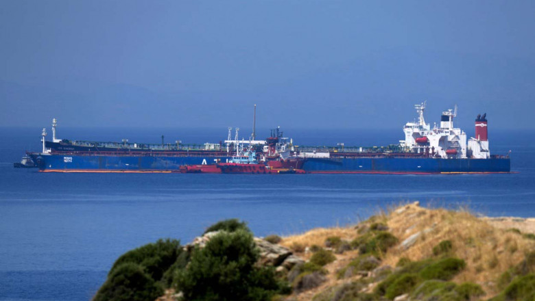 The Pegas tanker, that has recently changed its name to Lana, foreground, is seen off the port of Karystos on the Aegean Sea island of Evia, Greece