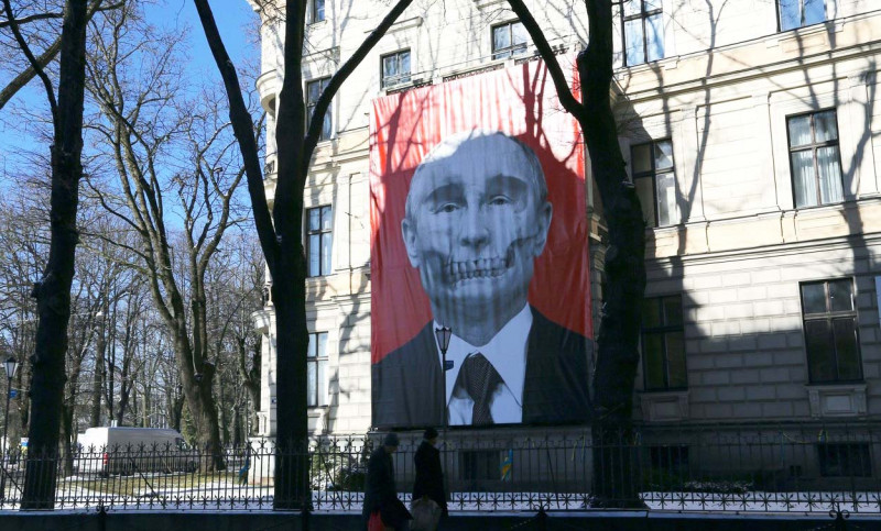 Riga, Latvia. 09th Mar, 2022. A large poster with a portrait of Russian President Vladimir Putin styled as a skull hangs on the facade of the Museum of Medical History in Latvia's capital, Riga. Credit: Alexander Welscher/dpa/Alamy Live News