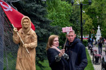 Voronezh, Russia, 09/05/2022, A couple takes a selfie with Donbass grandmother, a propaganda symbol of military aggression, on the 77th anniversary of the Victory Day in Voronezh. Victory Day in Russia has long turned from a day of memory of the feat of t