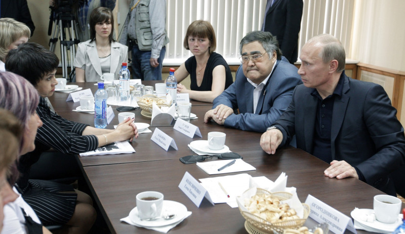 Russian Prime Minister Vladimir Putin speaks with relatives of deceased miners and mine rescuers