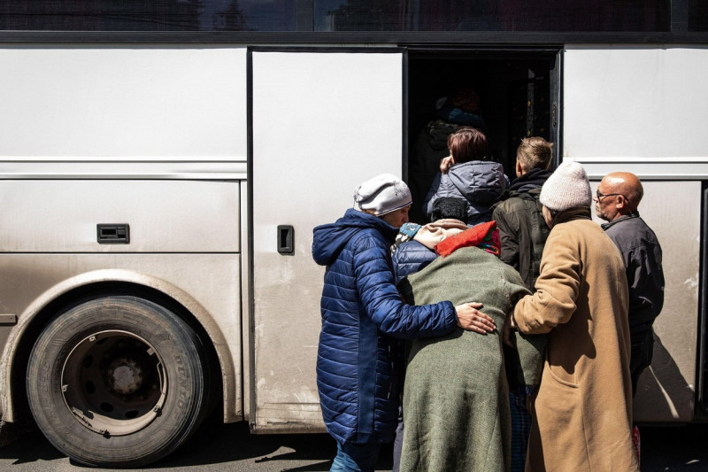 Bakhmut, Ukraine. 23rd May, 2022. Two sisters hold their mother to board an emergency evacuation bus. Donetsk(Donbas) region is under heavy attack, as Ukraine and Russian forces contest the area, amid the Russian full invasion of Ukraine started on Februa