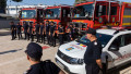 Romanian firefighters stand in front of fire engines during a ceremony, in Athens, on Saturday, July 2, 2022.
