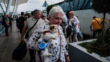Staff from Russia's diplomatic mission and their families arrive at Sofia Airport prior to their departure on July 3,