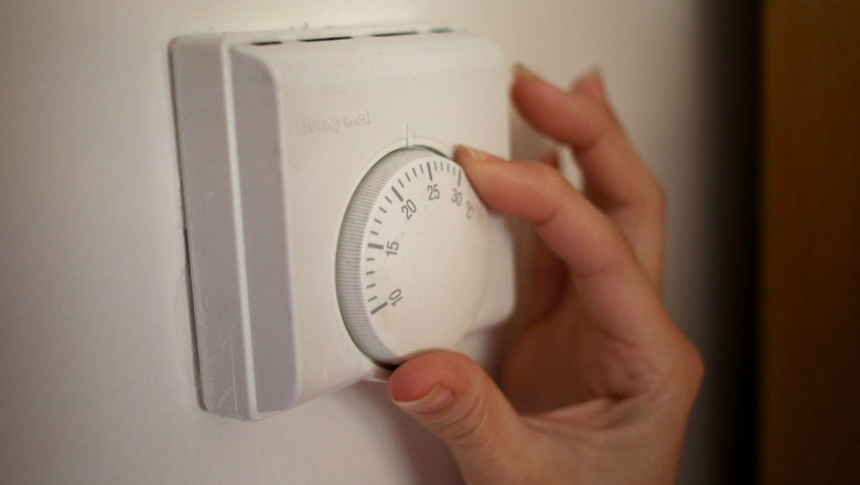 Undated file photo of a person using a central heating thermostat, as industry experts will advise the Scottish Government on how to effectively decarbonise homes.