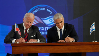U.S. President Joe Biden, left, and Israel's Prime Minister Yair Lapid, sign a security pledge at the Waldorf Astoria Hotel in Jerusalem