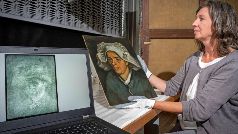 A handout picture released by the National Galleries of Scotland on July 14, 2022 shows senior conservator Lesley Stevenson viewing "Head of a Peasant Woman" alongside an X-ray image of a hidden self-portrait of Dutch painter Vincent Van Gogh in Edinburgh