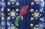 Flowers are left and tv news standing outside Ivana Trumpâ€™s Apartment After The News Of Ivana Passing Away At The Age Of 73