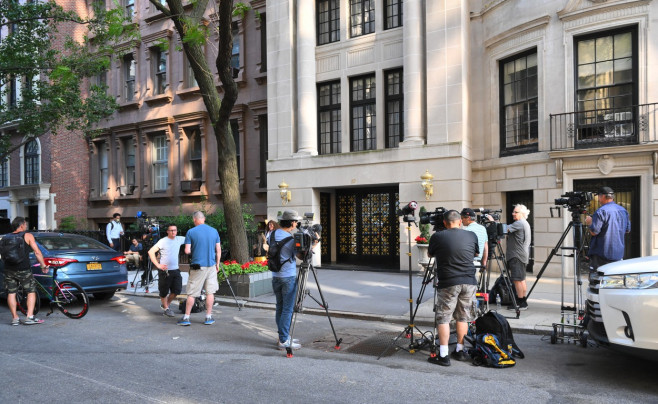 Flowers are left and tv news standing outside Ivana Trumpâ€™s Apartment After The News Of Ivana Passing Away At The Age Of 73