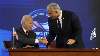 U.S. President Joe Biden and the Prime Minister of Israel Yair Lapid shake hands after signing a security pledge