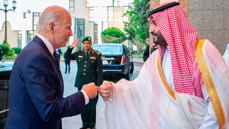 Saudi Crown Prince Mohammed bin Salman, right, greets President Joe Biden, with a fist bump after his arrival in Jeddah