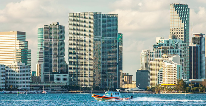 boat of the coast guard in front of the skyline of miami florida usa