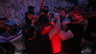 Relatives of Palestinians Mohammad Al-Azizi and Abboud Sobh, who were killed by Israeli forces, mourn during their funeral in the West Bank city of Nablus
