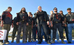 Russian President Vladimir Putin, center, stands with members of the Night Wolves biker club and their leader Alexander Zaldastanov, center left, as he addresses the Babylon Shadow bike show and camp August 10, 2019 near Sevastopol, Crimea, Russia.