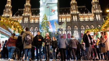 Visitors explore a Christmas market in front of Vienna's city hall in Vienna