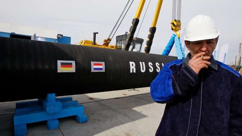 Russian construction worker smokes in Portovaya Bay some 170 kms (106 miles) north-west from St. Petersburg, Russia, during a ceremony marking the start of Nord Stream pipeline construction