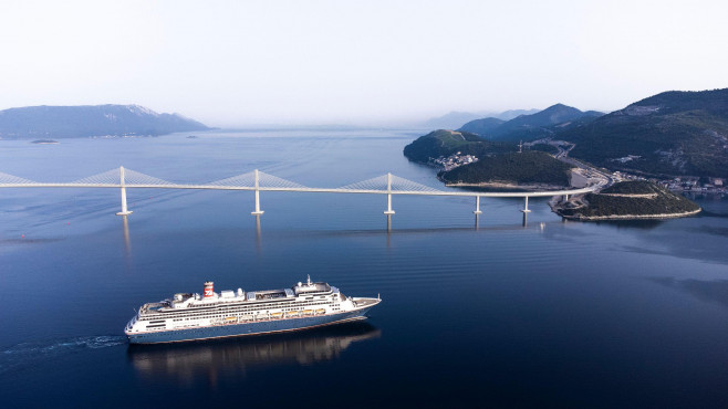 Komarna, Croatia. 23rd June, 2022. Aerial photo of the passage of the first large cruiser under the Peljesac Bridge in Komarna, Croatia on June 23, 2022. The cruiser Bolette under the command of Dubrovnik Captain Jozo Glavic with just over a thousand pass