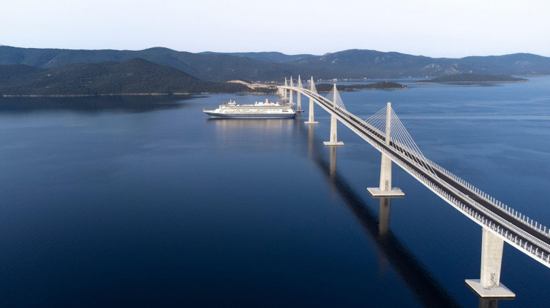 Komarna, Croatia. 23rd June, 2022. Aerial photo of the passage of the first large cruiser under the Peljesac Bridge in Komarna, Croatia on June 23, 2022. The cruiser Bolette under the command of Dubrovnik Captain Jozo Glavic with just over a thousand pass