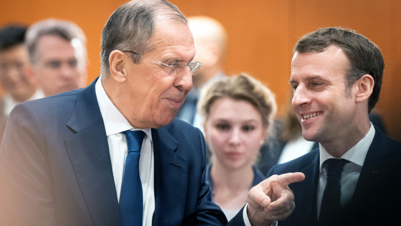Russian Foreign Minister Sergei Lavrov (L) talks with France's President Emmanuel Macron at the start of a Peace summit on Libya at the Chancellery in Berlin, on January 19, 2020
