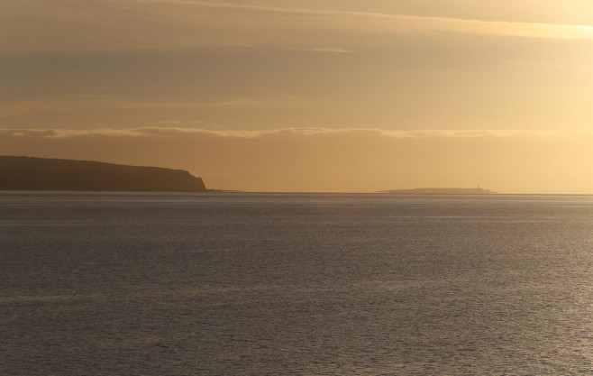 Island of Pladda with the cliffs of Bennan Head Isle of Arran at dawn Scotland September 2016