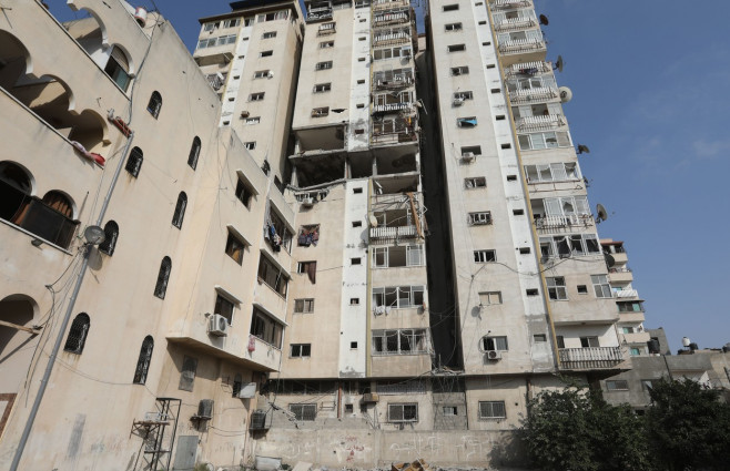 Palestinians gather near a building following an Israeli air strike in Gaza, Gaza city, Gaza Strip, Palestinian Territory - 05 Aug 2022