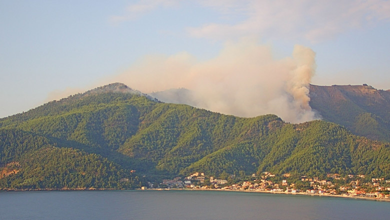 These images and video, captured on a webcam opposite Golden Bay on the island of Thassos, Residents of a village on the island of Thassos, in the north Aegean, show a large wildfire that broke out in a pine forest on the east of the island on Wednesday night (10August2022)