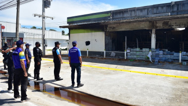 Thai bomb squad personnel and officials inspect the damage after an attack on convenience stores, in Cho-airong district in southern Thailand's Narathiwat province, on August 17, 2022