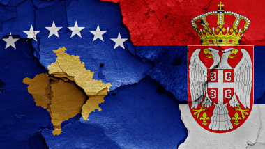 flags of Kosovo and Serbia painted on cracked wall