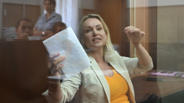 Marina Ovsyannikov speaks from inside a defendants' box during a court session over charges of "discrediting" the Russian army