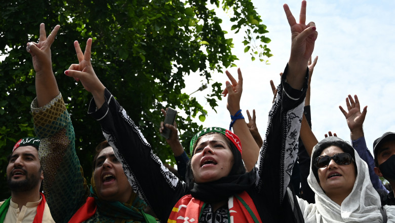 Supporters of Pakistan's former prime minister Imran Khan shout slogans as they guard outside the Khan's residence in Islamabad on August 22, 2022. Pakistan opposition leaders warned on August 22 that authorities would cross a "red line" if they arrested former prime minister Imran Khan after he was reported under the anti-terrorism act