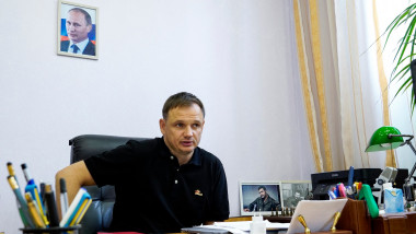 Kirill Stremousov, deputy head of the Russian-backed Kherson administration, is pictured in his office, with a portrait of Russian President Vladimir Putin seen on the wall behind him, in the city of Kherson on July 20, 2022