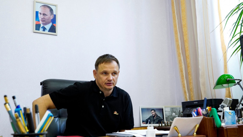 Kirill Stremousov, deputy head of the Russian-backed Kherson administration, is pictured in his office, with a portrait of Russian President Vladimir Putin seen on the wall behind him, in the city of Kherson on July 20, 2022