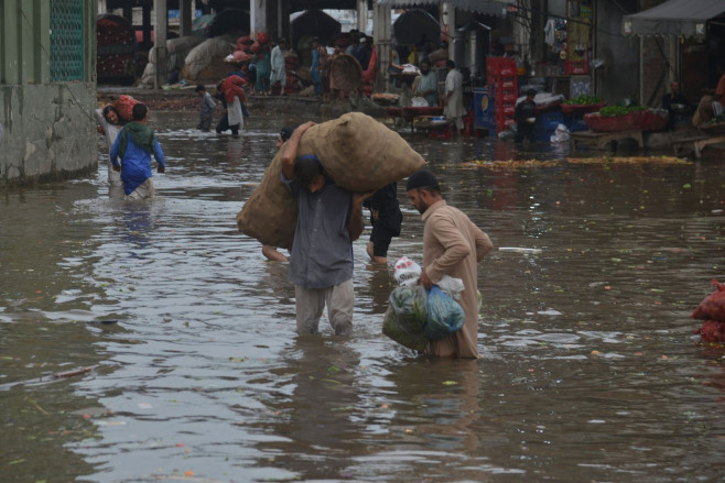 Pakistani busy on their way to Badami Bagh vegetable market during heavy monsoon rainfall, Lahore, Punjab, Pakistan - 29 Aug 2022