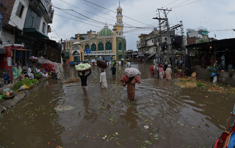 Pakistani busy on their way to Badami Bagh vegetable market during heavy monsoon rainfall, Lahore, Punjab, Pakistan - 29 Aug 2022