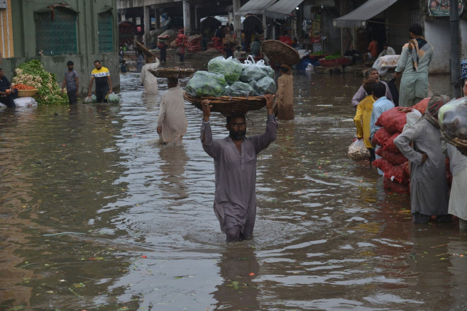 Pakistani busy on their way to Badami Bagh vegetable market during heavy monsoon rainfall, Lahore, Punjab, Pakistan - 29 Aug 2022