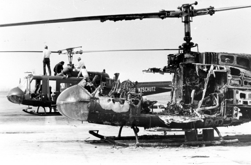 Incident at the Munich Olympics, 1972. Helicopter wreckage. Experts examine the wreckage of two German Border Police helicopters at Fuerstenfeldbrueck, near Munich. The helicopter in the foreground is burnt out after a hand grenade explosion. Nine Israeli