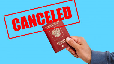 Russian foreign passport in the hands of a man with canceled on it