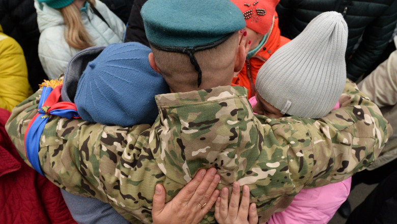 Relatives say goodbye to men conscripted for military service during partial mobilisation before their leaving for additional training, in Chelyabinsk, Russia