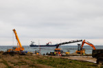 Puttgarden, Germany. 29th Nov, 2021. Excavators stand on the construction site through which the Fehmarnbelt Tunnel will pass. During a ceremony on the island of Fehmarn, the symbolic groundbreaking was celebrated. Credit: Frank Molter/dpa/Alamy Live News