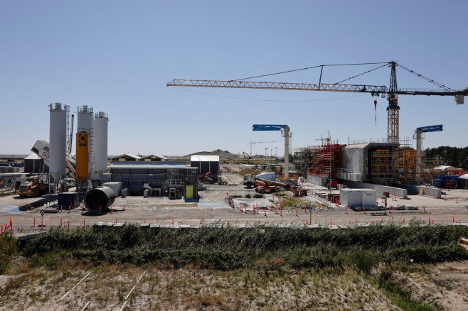 Rodby, Denmark. 12th Aug, 2022. Work equipment stands at a construction site of the Fehmarnbelt Tunnel. The 17.6-kilometer-long transport link between Germany and Denmark is scheduled for completion by 2029. Schleswig-Holstein's Transport Minister Madsen