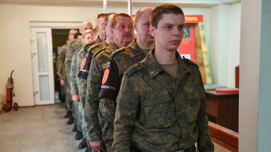 Service members of LPR militia arrive for voting during the referendum on the republic to become integral part of Russia at a polling station in Luhansk