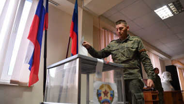 A service member of LPR militia casts his ballot during the referendum on the republic to become integral part of Russia at a polling station in Luhansk, Luhansk People's Republic. The people's republics of Donetsk and Luhansk